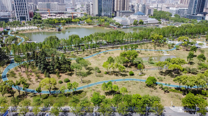 Aerial View of Houxiang River Park Urban Wetland and City Skyline in China © PhamHong