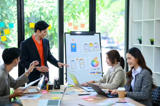 Developer and UX UI Designer Team Discussing Mobile App Design in Modern Office Meeting