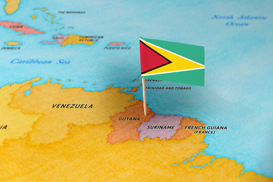 Guyana flag pin marking Guyana on South America map, travel destination concept