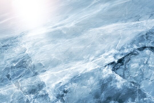 A serene icy landscape with translucent frozen water and cracks, illuminated by soft sunlight reflecting off the surface.