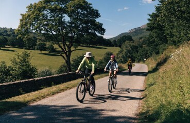 Naklejka premium Family Cycling on a Scenic Countryside Road Surrounded by Rolling Green Hills and Lush Trees