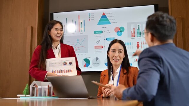 Business Meeting with Data Presentation and Visual Charts in Conference Room