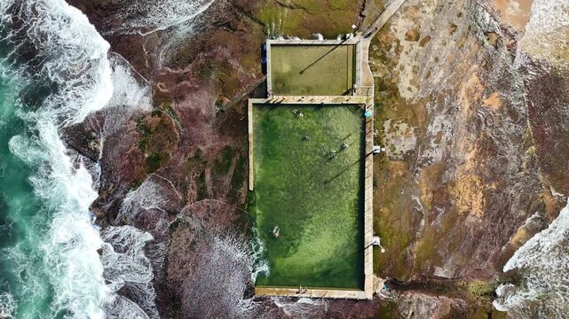 Drone video aerial view of a beach rock pool near a beach in Sydney Australia in Summer on vacation 