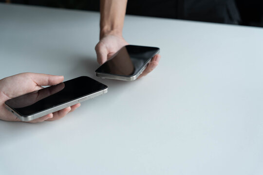 Man using smartphone close contect transfer file by wireless technology