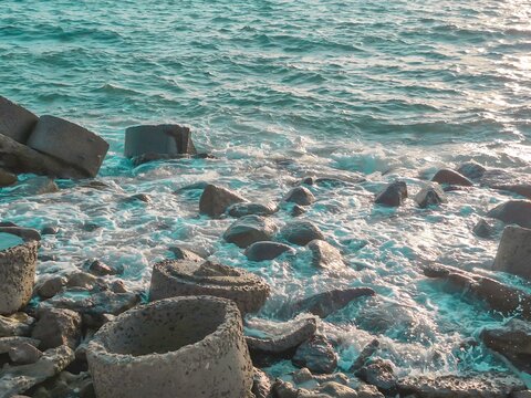 Turquoise Ocean Water with Black Volcanic Rocks on Indonesian Tropical Coastline