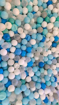 Blue, White, and Transparent Plastic Balls Background in a Children's Ball Pit Playground