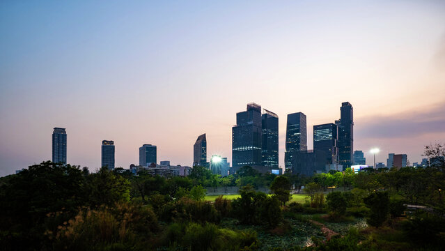 Energetic panorama view of Bangkok CBD, city lifestyle and traffic movement during the blue hour.