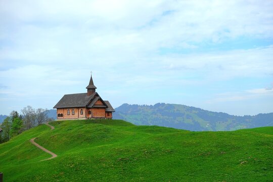 Stoos chapel, a Timber-framed church on lush green alpine hillin the village of Stoos