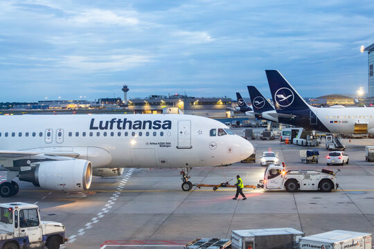 Frankfurt, Germany - May 20, 2026: Commercial passenger airplane at airport terminal gate with pushback tug tractor towing aircraft and ground support