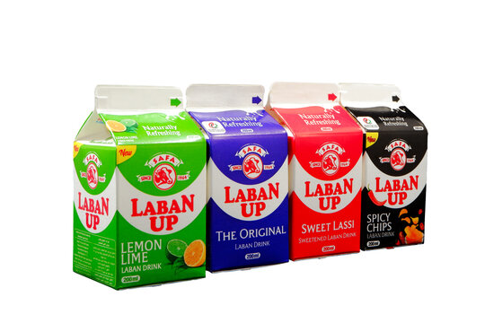 Four laban up drink cartons showcasing lemon lime, original, sweet lassi, and spicy chips flavors are presented in a clean, professional studio shot.