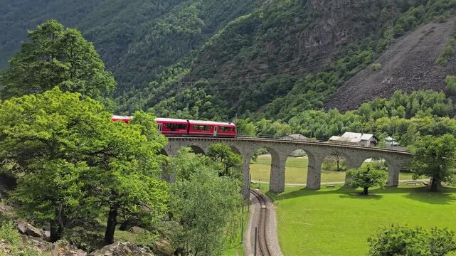 Bernina Express making a famous 360 degree turn on Brusio spiral viaduct of Rhaetian Railway