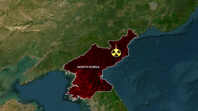 Animated map footage showing North Korea glowing red with nuclear radiation symbol motion