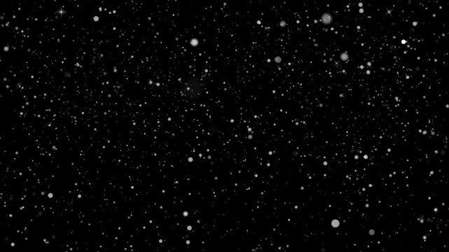 Particles drift slowly across a dark void creating a subtle and minimalist texture for creative graphic design projects.
