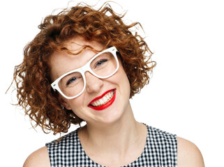 Obraz premium Cheerful woman with curly red hair wearing white glasses, happy smiling female with ginger curls, stylish lady in checkered dress on white background