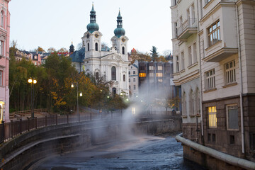Naklejka premium Autumn view of Karlovy Vary with Church of St. Mary Magdalene above Tepla River, Czech Republic. g.
