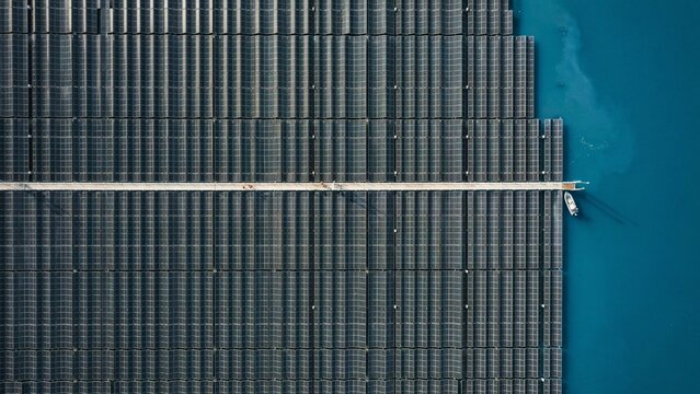 Aerial Top Down View of Floating Solar Panel Farm on Water Reservoir, Renewable Energy,  The Geometric Float voltaic Array