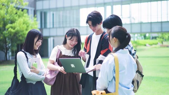 パソコンを囲む大学生