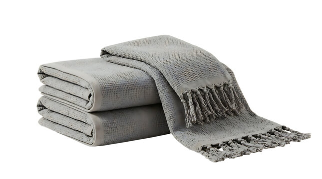 Stack of soft folded grey bath towels with textured waffle weave and knotted fringe ends.