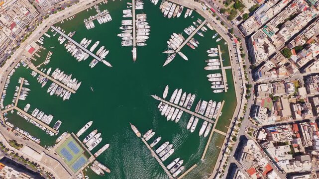 Hypnotic and surreal aerial top-down view of the octagonal zea marina, showing yachts and sailboats docked in the harbor of piraeus, creating an abstract and mesmerizing kaleidoscopic pattern