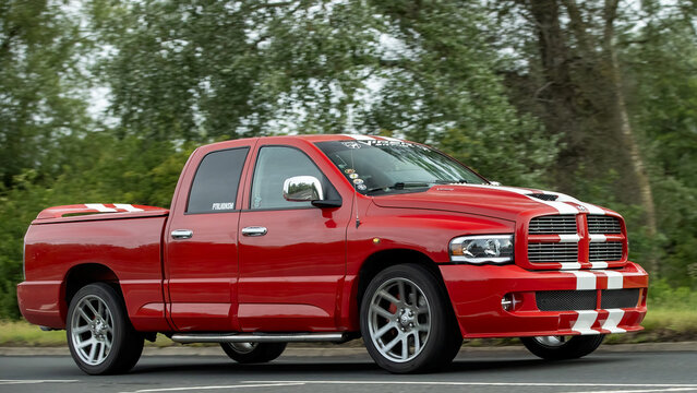 Stony Stratford,Bucks,UK - June 7th 2026:   Red Dodge RAM srt 10 viper sport pickup truck driving on a British road