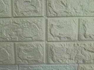 Fototapeta premium Close up of a white faux stone brick wall texture panel.