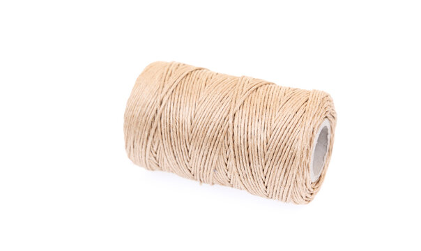 Natural jute twine spool isolated on white background, close-up of rustic string roll for packaging, crafting, wrapping and handmade projects with minimal design concept.