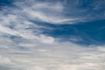 Fototapeta premium Peaceful sky vista. Quiet sky with gentle clouds. Serene atmosphere under multilayered cloud canopy. Calm and tranquil celestial scene with soft sunlight and distant horizons