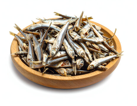 Wooden Bowl Piled with Dried Small Silver Anchovy Fish Ikan Teri Isolated on White Background for Sambal