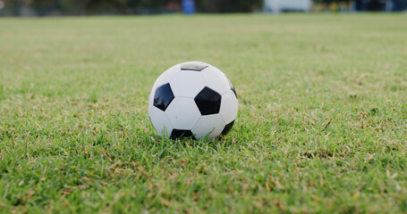Obraz premium Ground, space and sports with ball on soccer field for activity, competition or outdoor hobby. Fitness, green grass and training with object on empty pitch for start of game, match or tournament