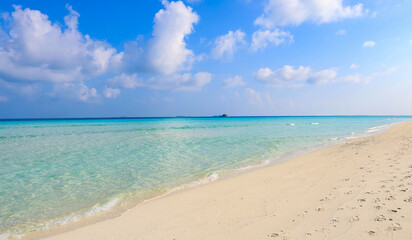 Fototapeta premium The background for summer vacation concept with the nature of clear water sea beach and summer with sunlight, sandy beach as The sparkling sea water contrasts with the blue sky