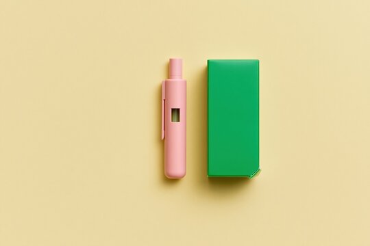 Pink medical injection pen with emerald green packaging for diabetes treatment, arranged in a smooth and airy flat-lay composition on a buttercream yellow surface