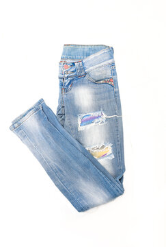 Women's blue skinny acid wash jeans on a white background