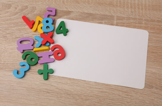 White blank card and children's toys  numbers on the table
