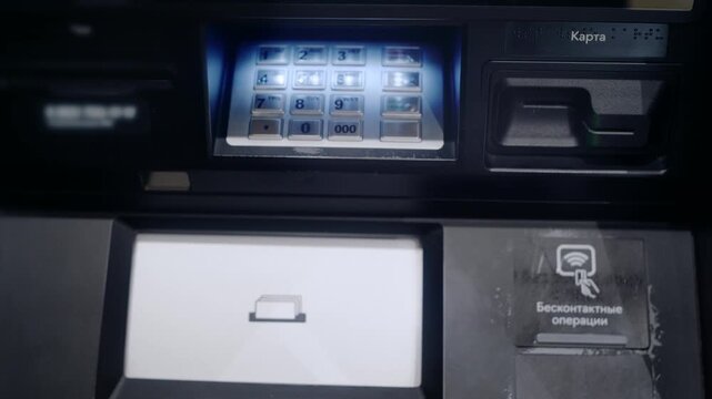 Man's hand entering a personal identification number on an automated teller machine keyboard