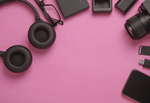 Equipment of modern photographer on a pink background. Top view. Flat lay