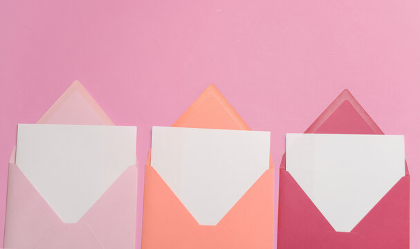 Pink envelopes with white blank letters on pink background. Creative layout