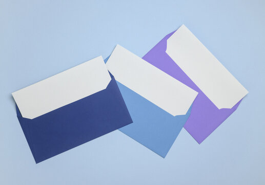 Colored envelopes with white blank letters on a blue background. Creative layout
