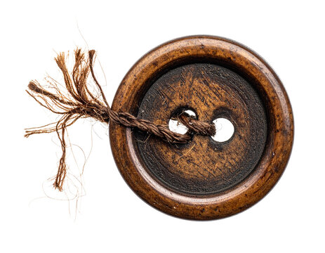old vintage wooden button with four holes, with a piece of frayed brown thread sticking out, isolated on transparent background