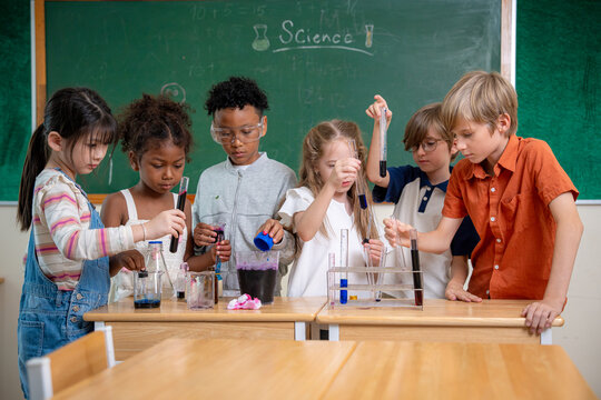 Diversity children doing a chemical experiment in laboratory at school. Kids at elementary school learning science chemistry. Fun study back to school. Education and research.