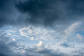 Obraz premium Dark cloudscape storm disaster gloomy gray cloud sky. Dramatic dark storm rain clouds black sky background. Meteorology danger windstorm disasters climate. Dark thunderstorm clouds rainny atmosphere