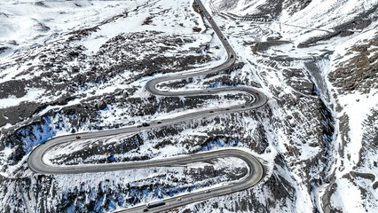 Fototapeta premium Los Caracoles highway road near Santiago Chile in aerial view. Snow highway road. Vertical video