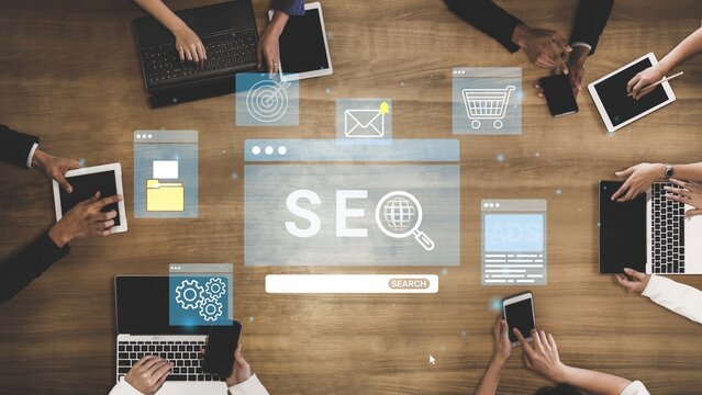 A dynamic meeting environment showcasing diverse hands engaged with digital devices, emphasizing SEO strategies and collaborative discussions for optimal marketing growth. Entropy.