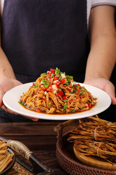 Chef Holding Spicy Stir-Fried Noodles with Fresh Vegetables