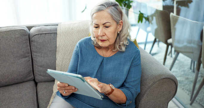 Tablet, online and senior woman on sofa in home with reading blog on pension funds, savings or finance. Digital technology, relax and elderly female person with retirement planning in living room.