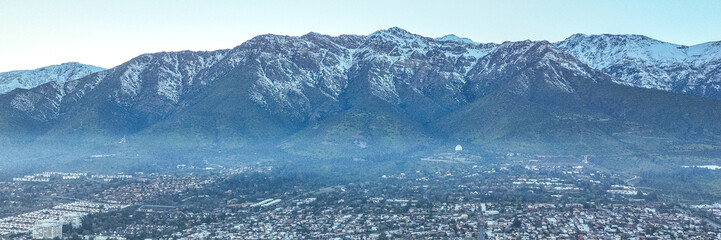 Fototapeta premium Santiago, Chile. Aerial view with the Andes mountain range in the background. Mountain range and snow-capped mountains.