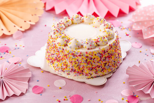 Delicious Cream cake for birthday party with pink paper decorations