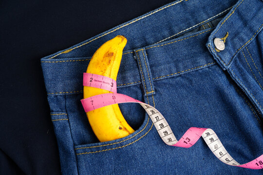Banana with measuring tape on jean trousers, penis health.