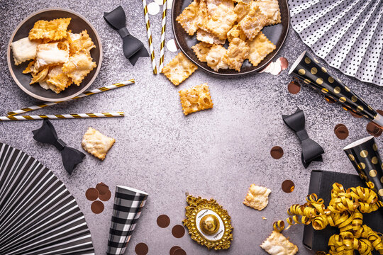 Overhead shot of  carnival or party decorations with  Chiacchiere as party food