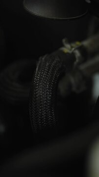  This is an automotive fuel line or crankcase ventilation hose with a protective braid.