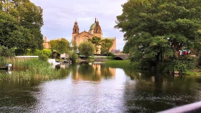 Majestic Galway Cathedral reflected in peaceful Corrib riverside landscape showcasing historic Irish architecture, serene nature, vibrant tourism and cultural heritage beauty